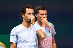 Neal Skupski and Wesley Koolhof talking on court