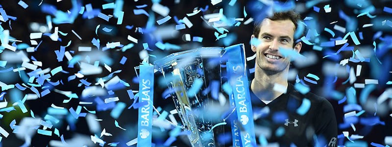 Andy Murray smiling with his trophy with confetti raining down