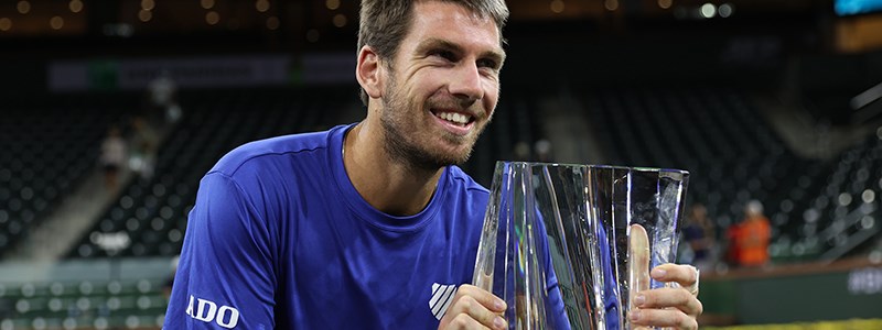 cam norrie smiling holding a trophy