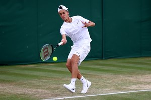 Patrick returning a serve mid game at a tennis game