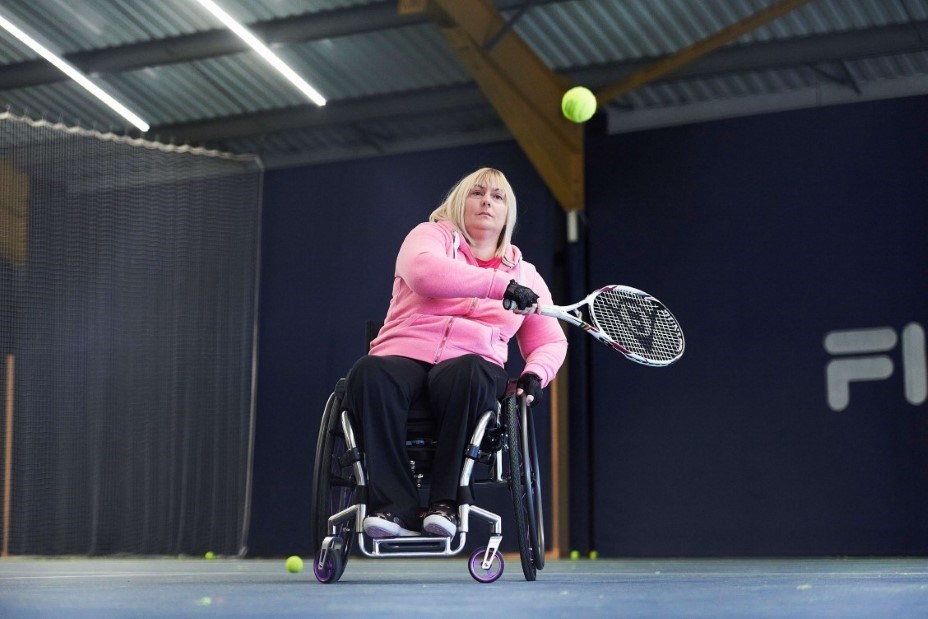 Female wheelchair player about to take backhand shot