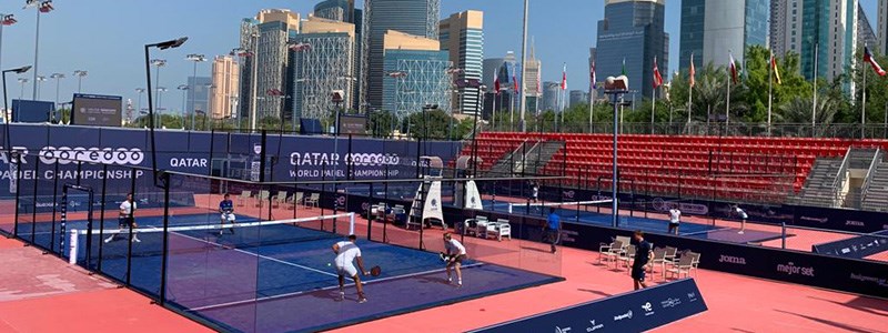 padel doubles match being played on outdoor court