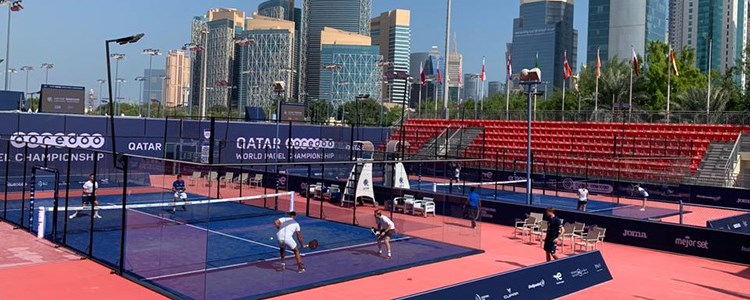 padel doubles match being played on outdoor court