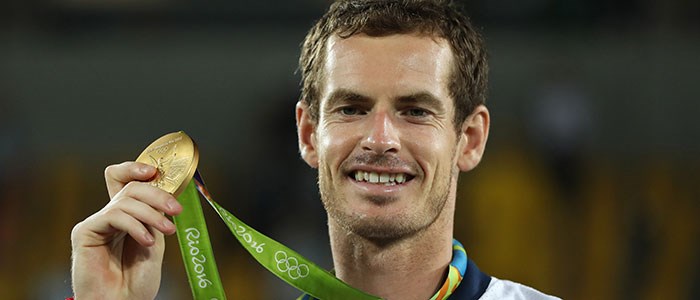 Andy Murray smiling with a Rio 2016 gold medal at the olympics