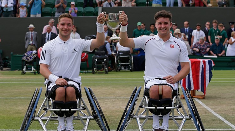 Hewett and Reid holding up their trophy at Wimbledon