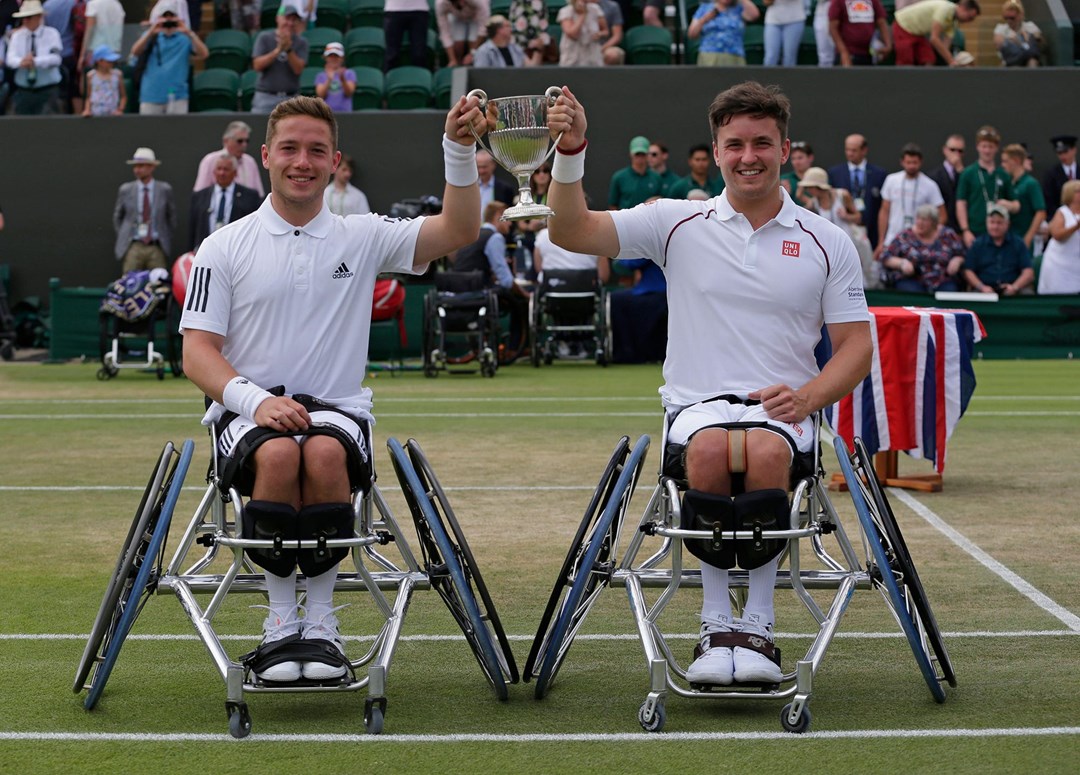 Hewett and Reid holding up their trophy at Wimbledon