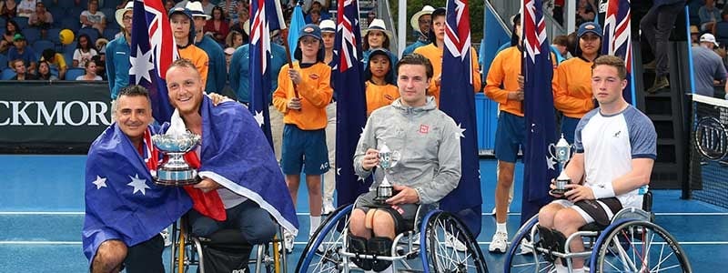 Gordon Reid and Alfie Hewett at the Australian Open smiling and holding their trophies with two other players