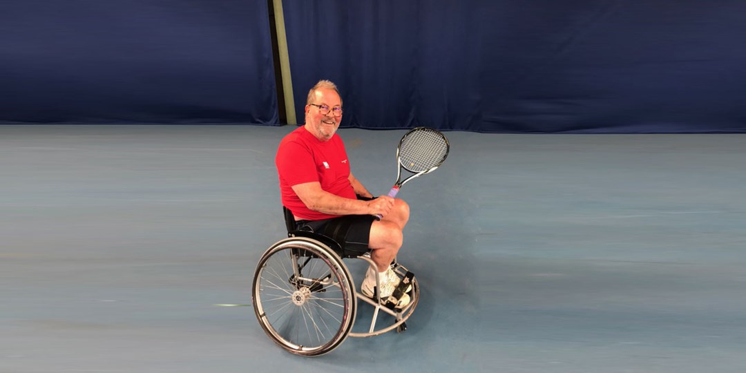 Steve Dargavel smiling and holding tennis racket