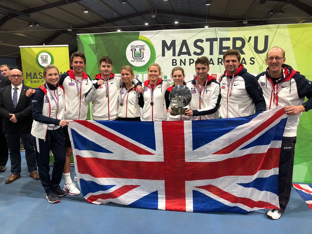 Great Britain University Tennis Team posing holding a large union jack flag