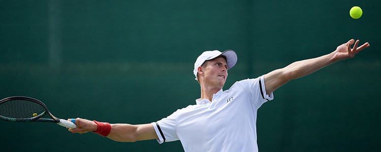 Billy Harris about to serve in a game of tennis