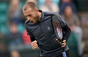 Dan Evans shouting with a racket in hand