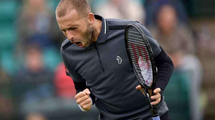 Dan Evans shouting with a racket in hand