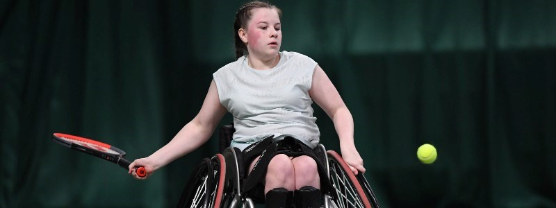 Girl playing tennis in wheelchair