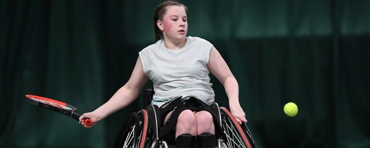 Girl playing tennis in wheelchair