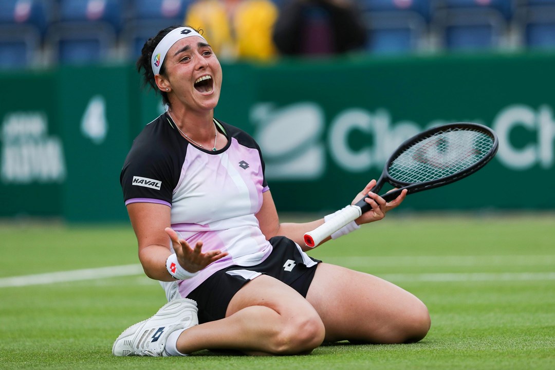 Female tennis player celebrating on her knees