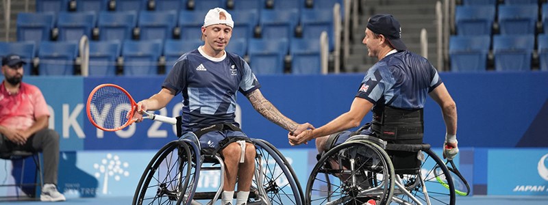 Two paralympic players shaking hands 