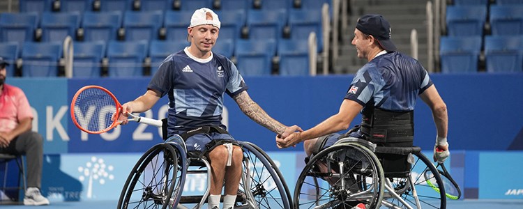 Two paralympic players shaking hands 