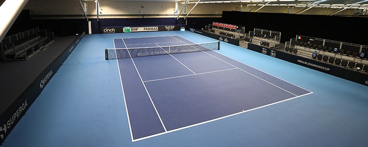A full shot of an empty blue tennis court