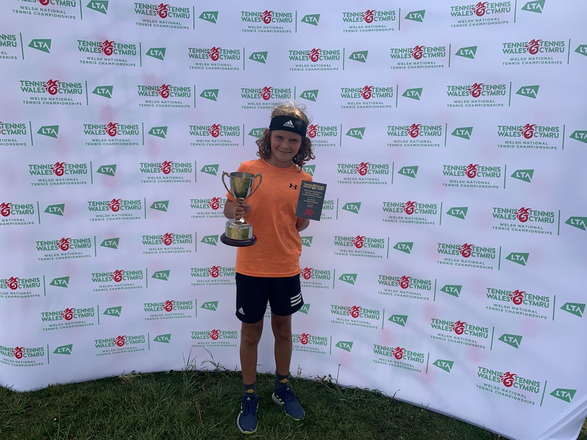 Young tennis player with an award