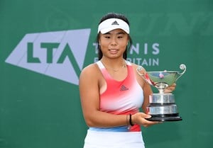 Female tennis player holding a trophy