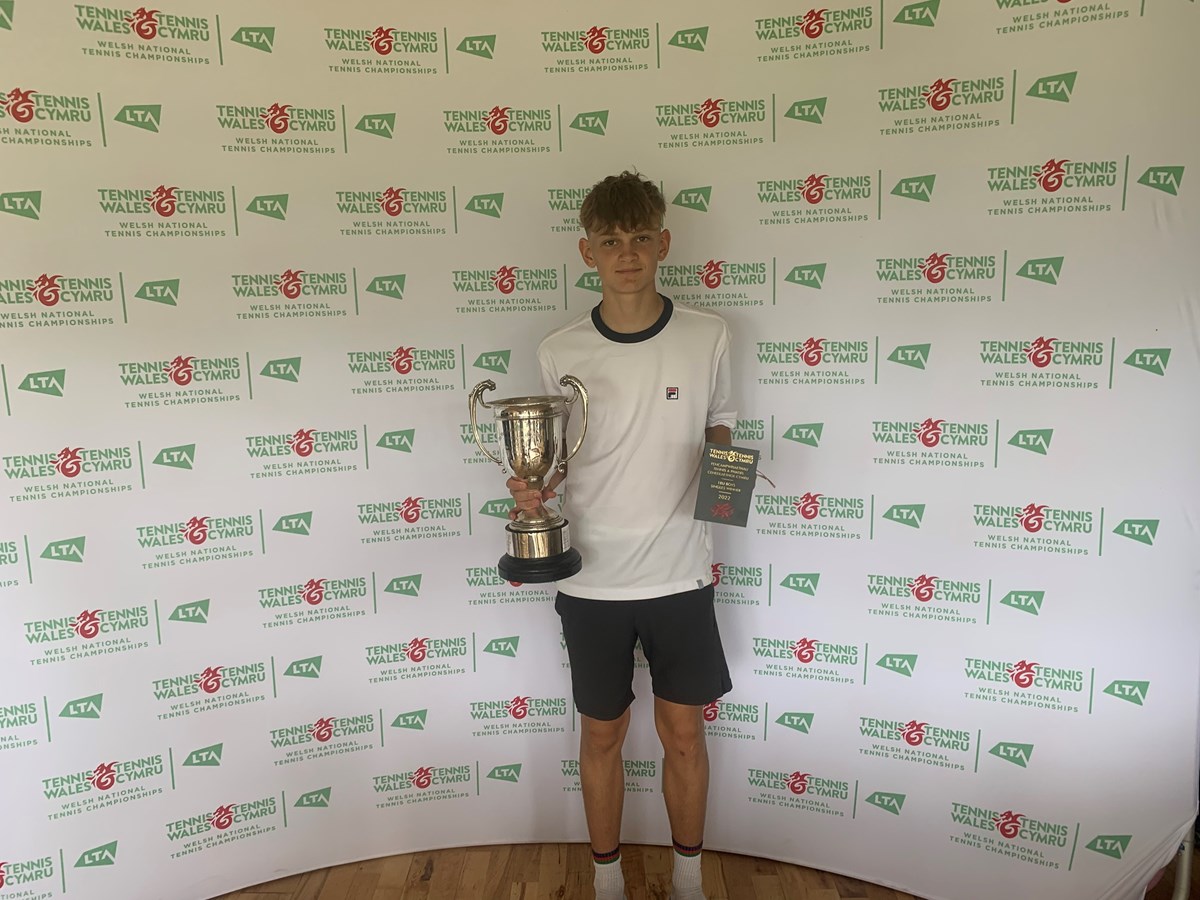 Simon posing infront of a tennis wales backdrop