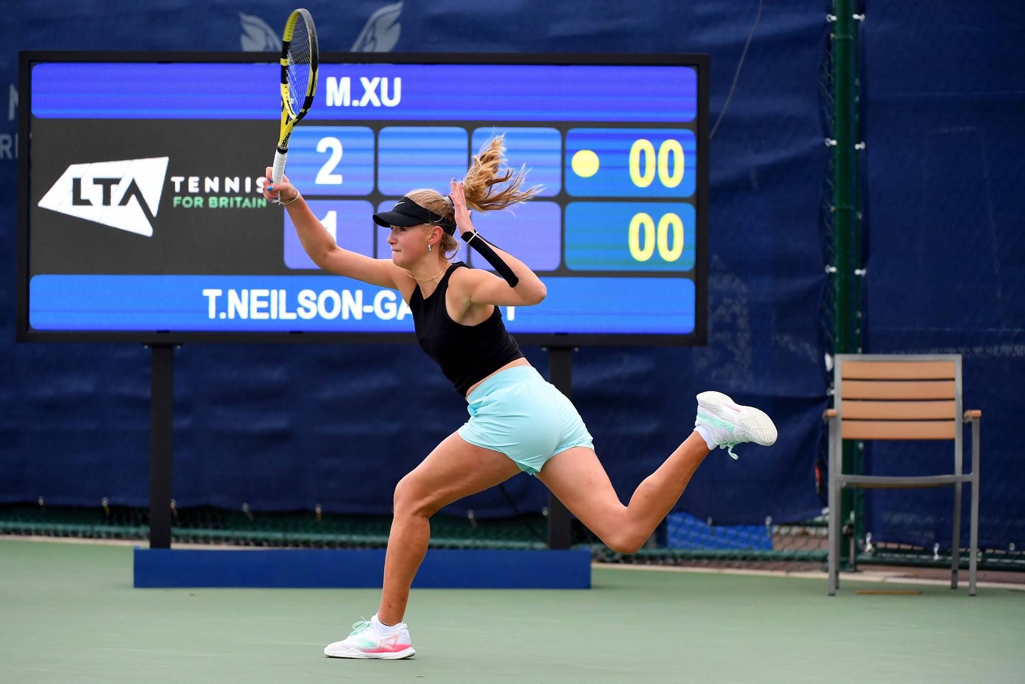 Female tennis player swinging her racket