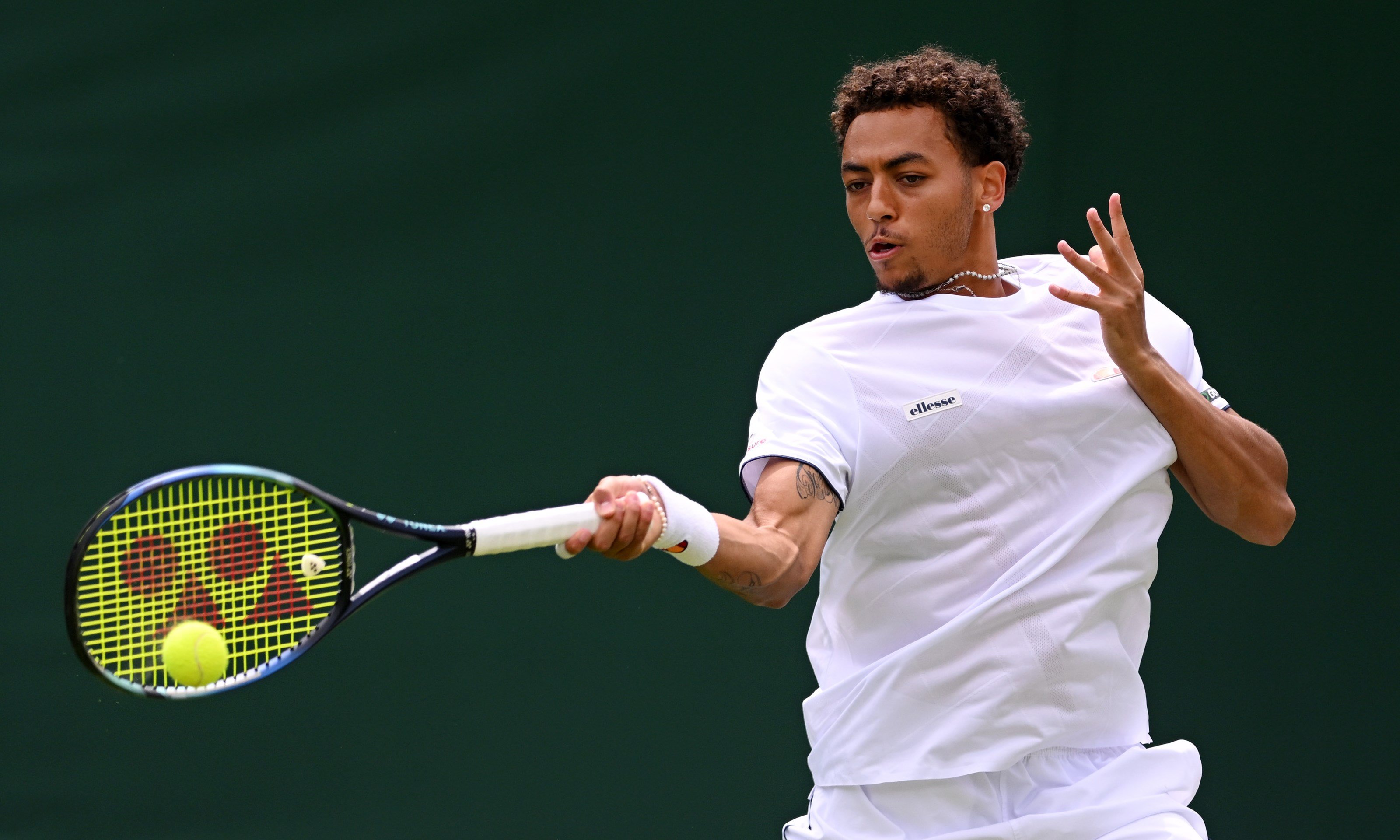 Paul jubb hitting a forehand at wimbledon