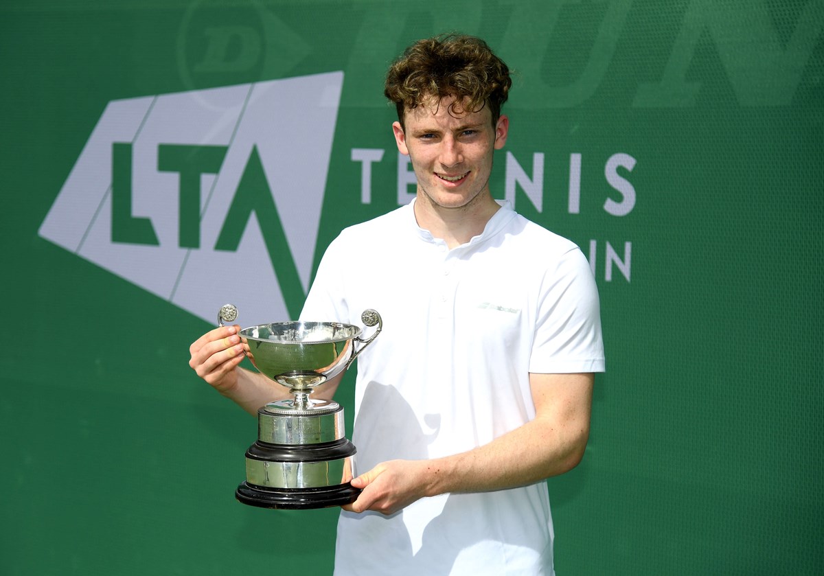 Male tennis player holding a trophy