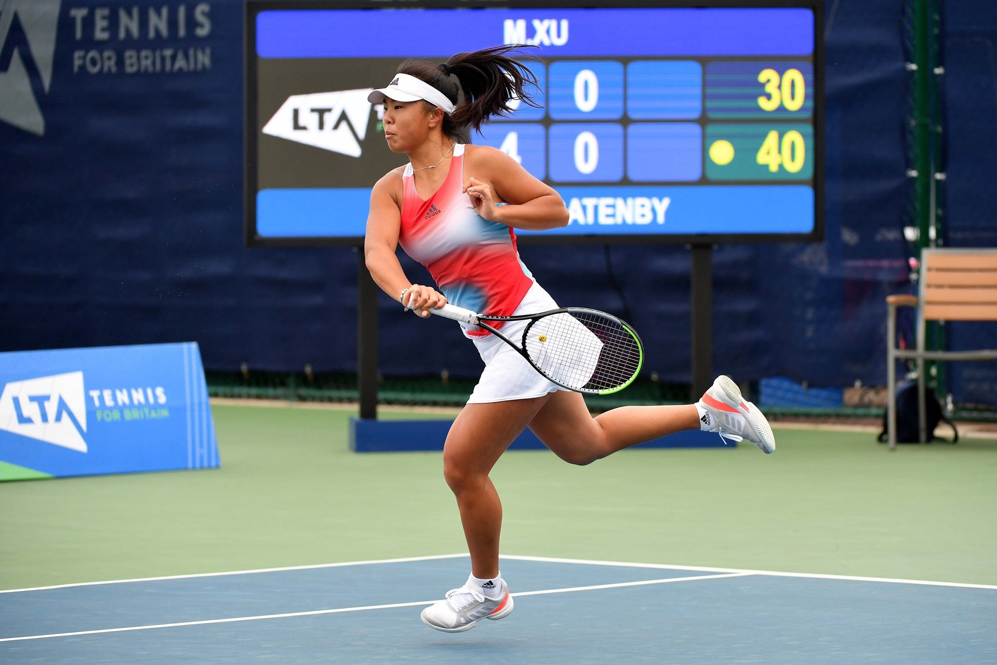 Female playing tennis