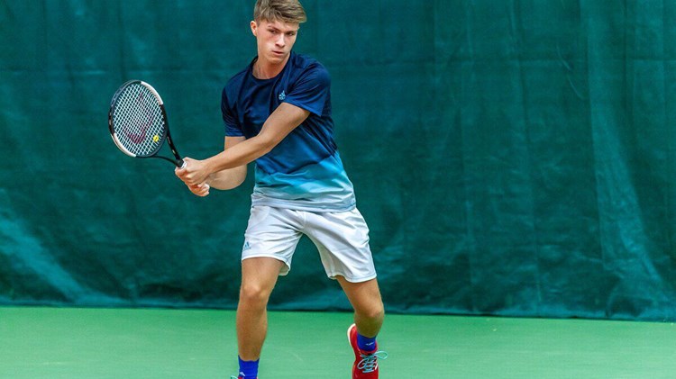 James returning a shot mid tennis game
