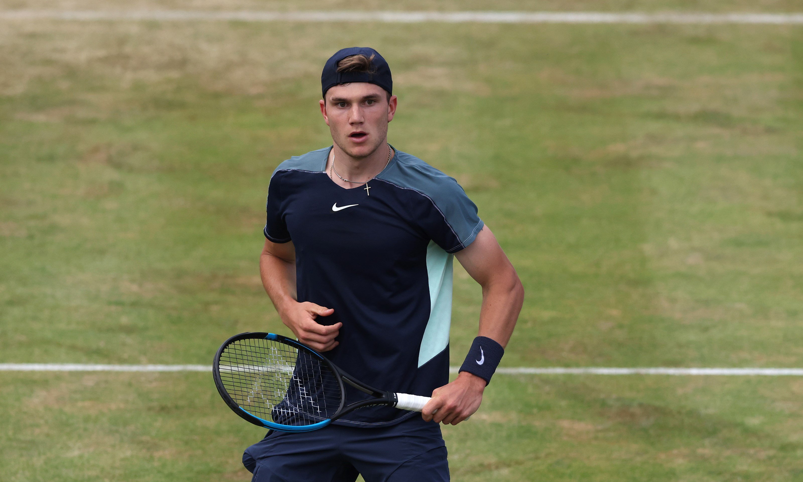 Jack draper holding a racket and looking forward