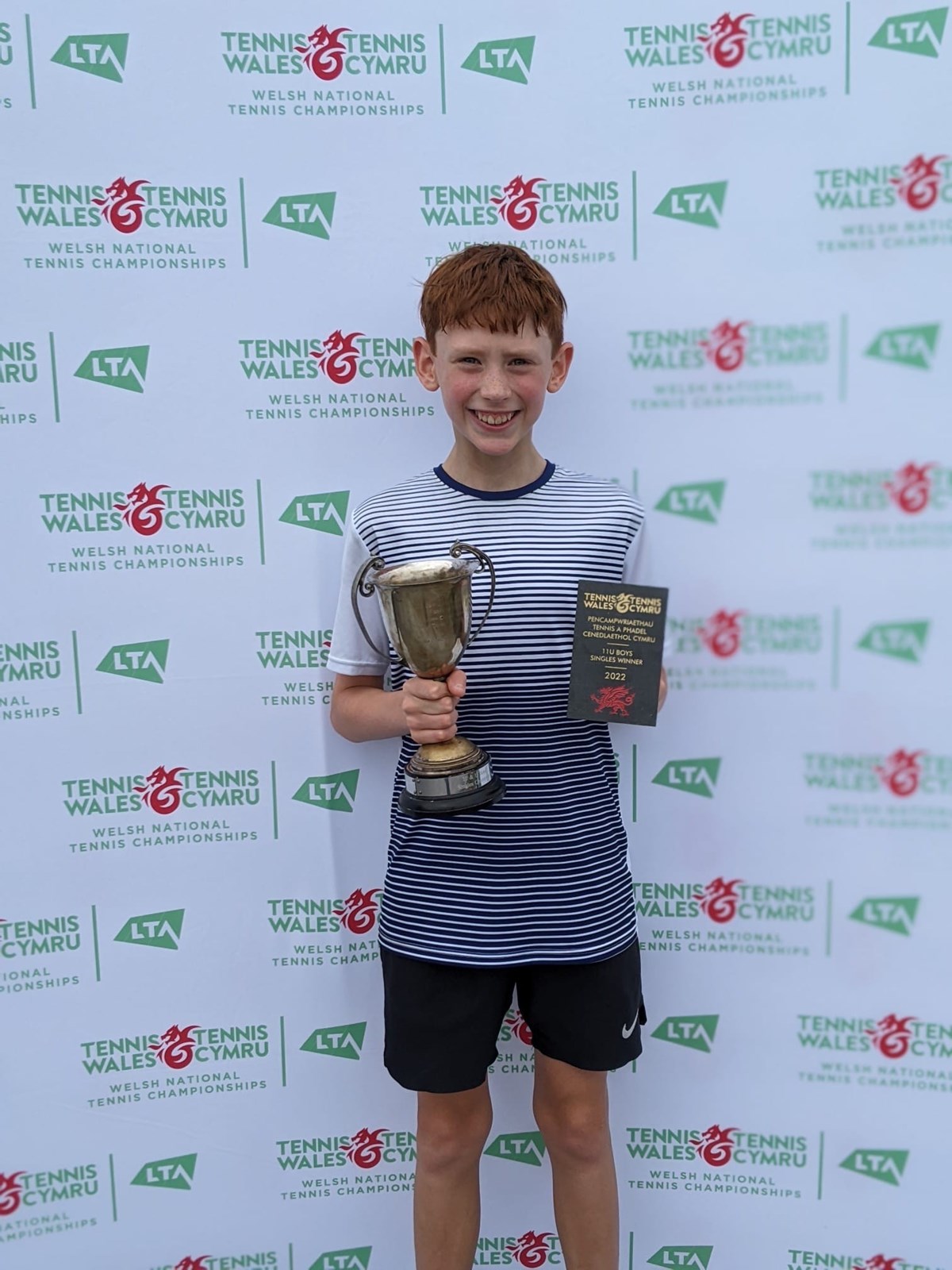 Maxle posing with his trophy infront of Tennis Wales