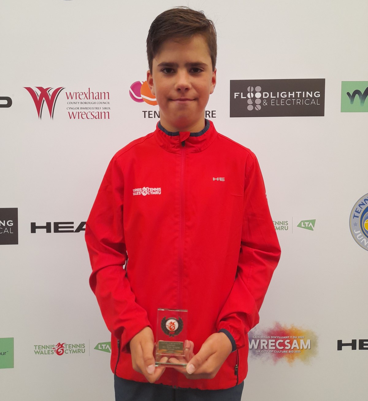 Boy with tennis trophy