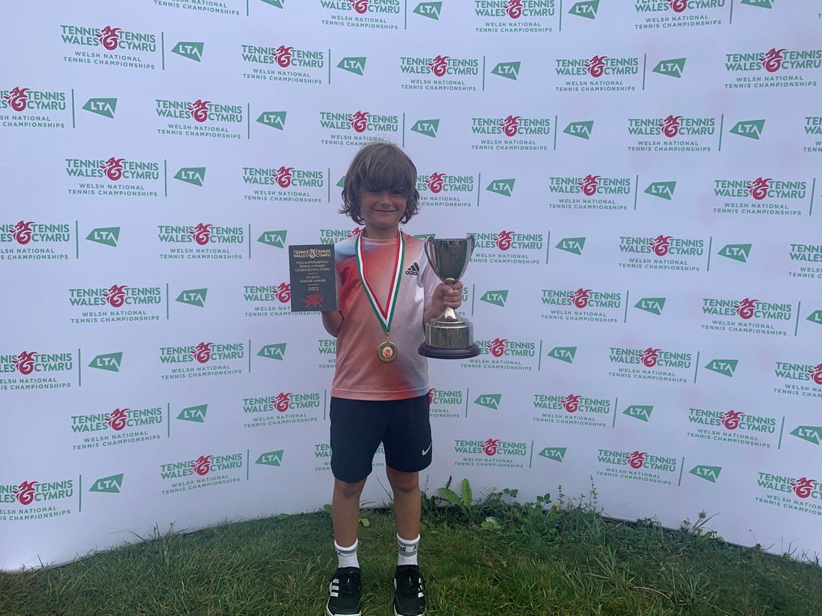 Fletcher Davies boy under 9 champion posing with his trophy