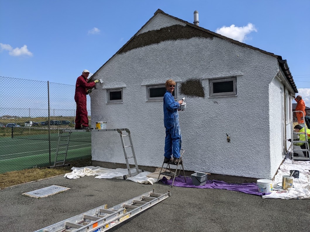 TW workers painting and decorating the tennis court building