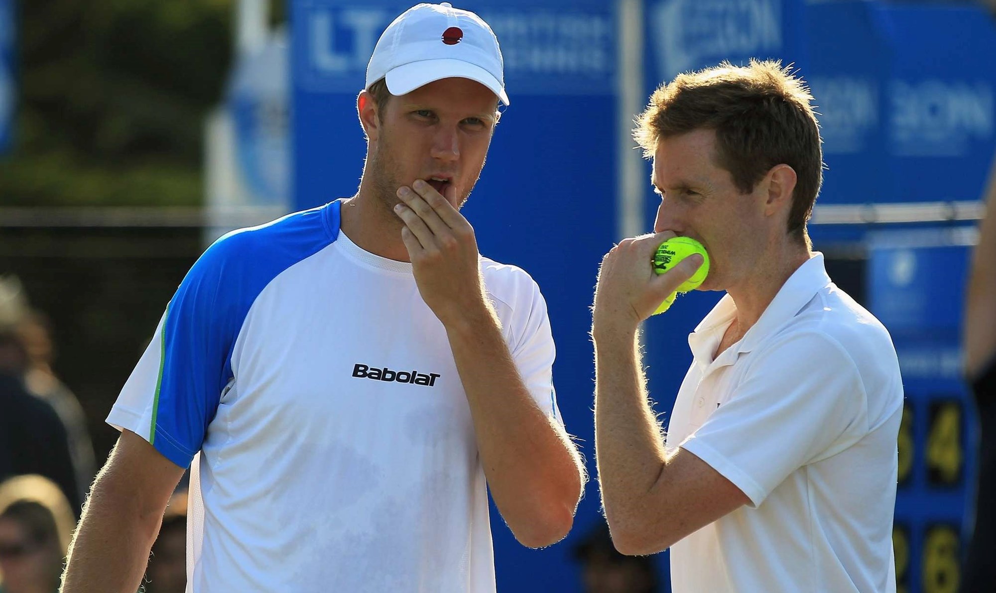 Two tennis player talking mid game