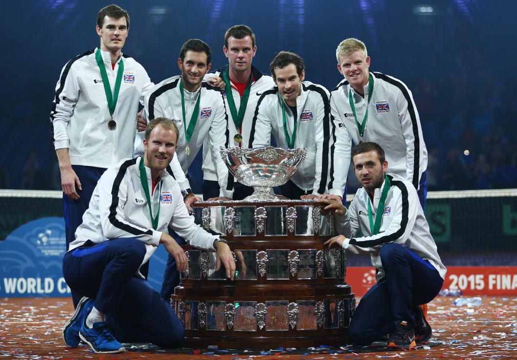 Great Britain players standing around a big trophy