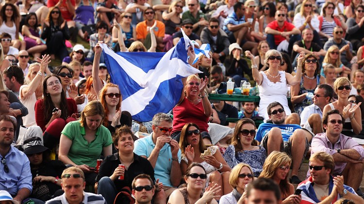 A big crowd of fans holding a Scotland flag