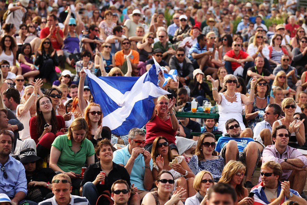 A big crowd of fans holding a Scotland flag