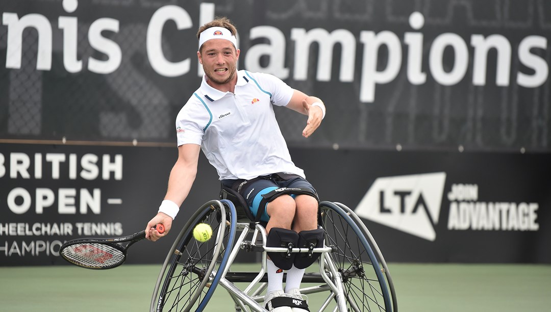 Paralympic tennis players swinging a racket