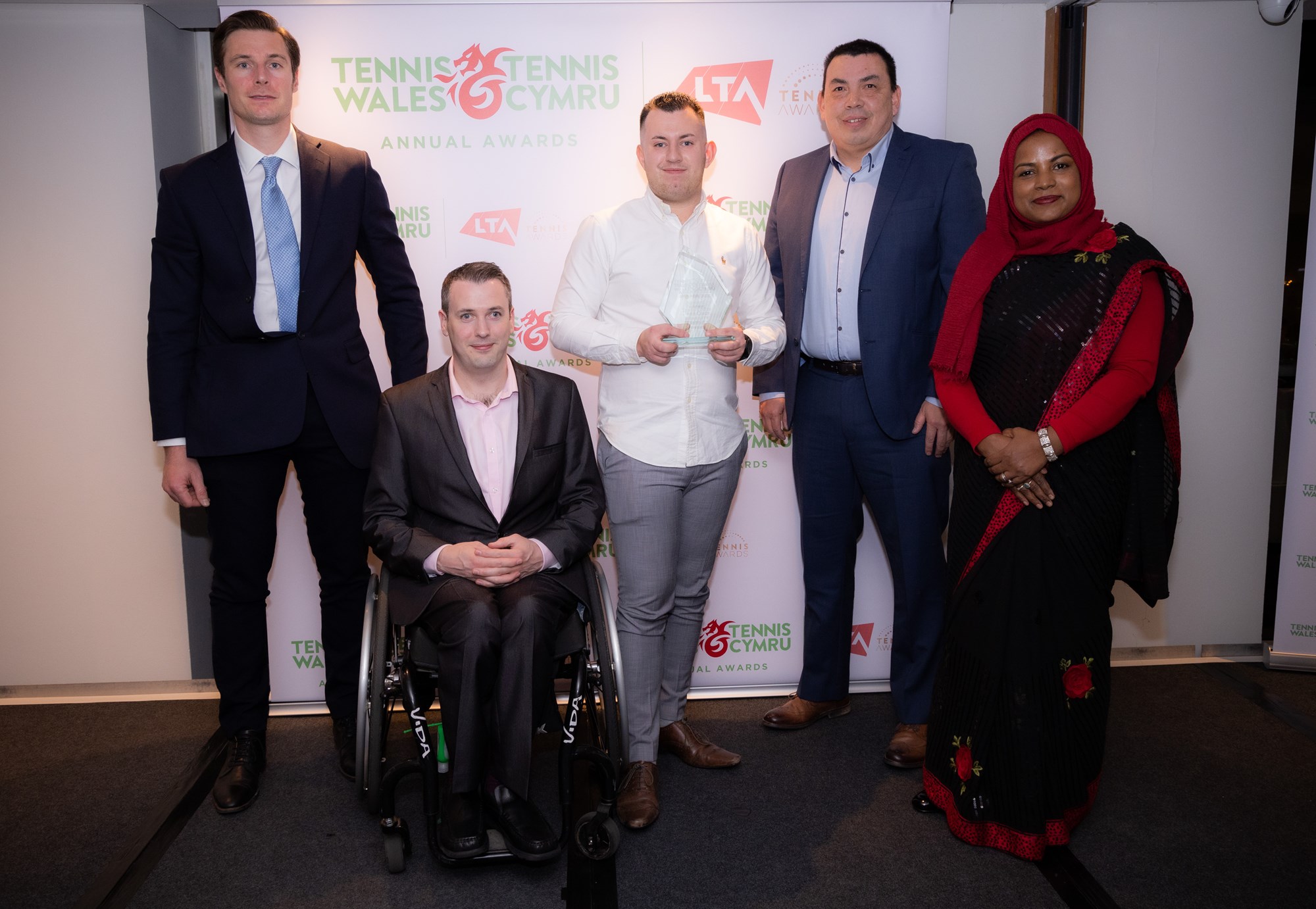 5 people standing at the tennis disability award show