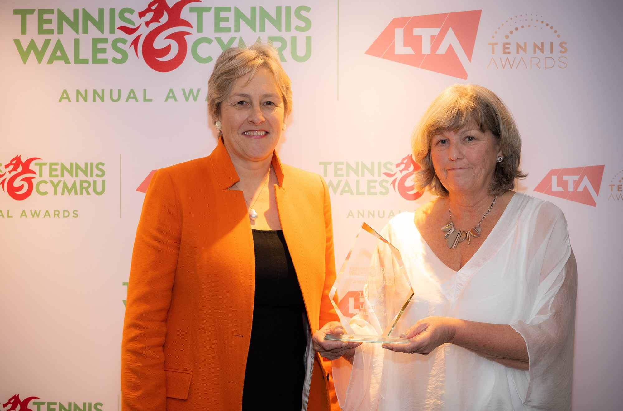Two women receving a tennis award at the wales ceremony 