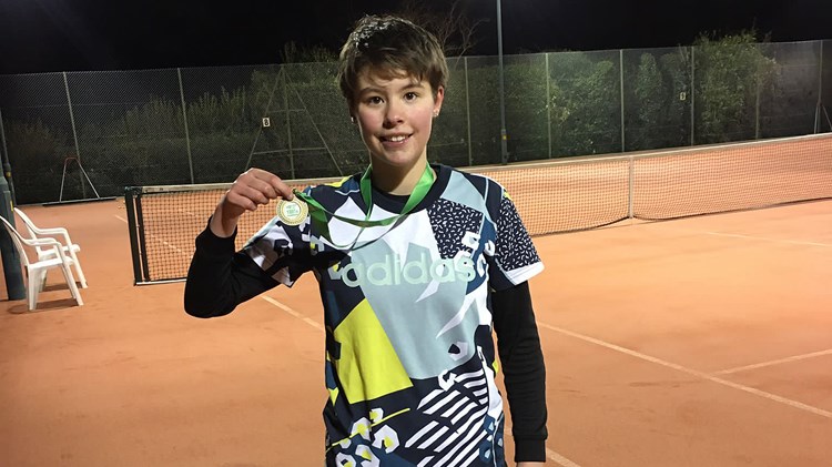 Boy with gold medal in his hand