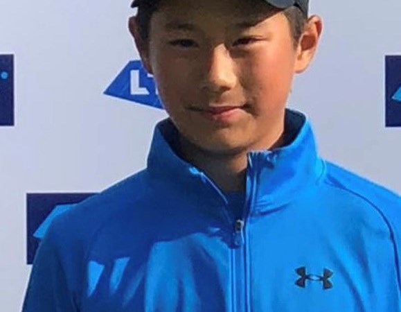 Rundong posing with a tennis trophy