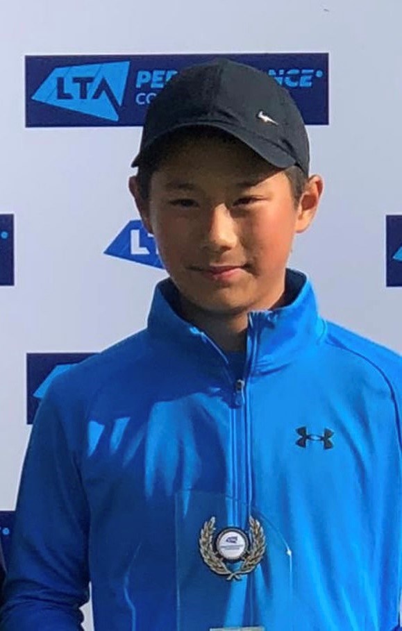 Rundong posing with a tennis trophy