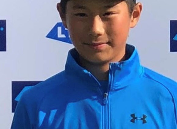 Rundong posing with a tennis trophy