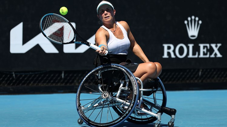 Female tennis player in a wheelchair holding a racket