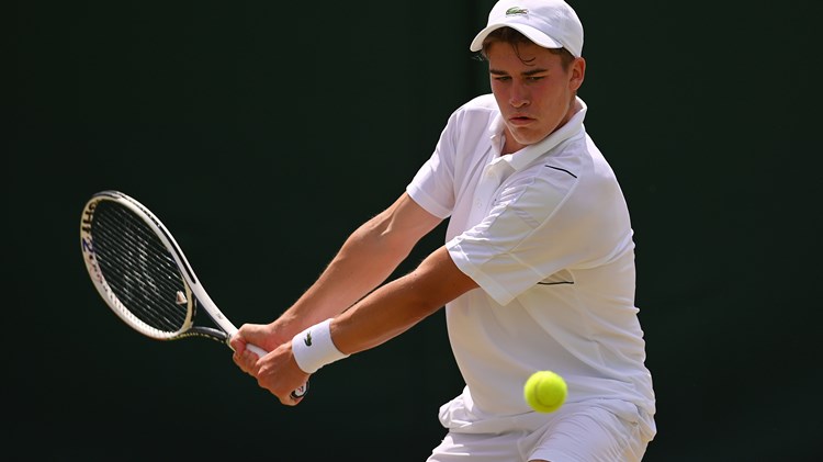 Male tennis player returning a shot in a rally 