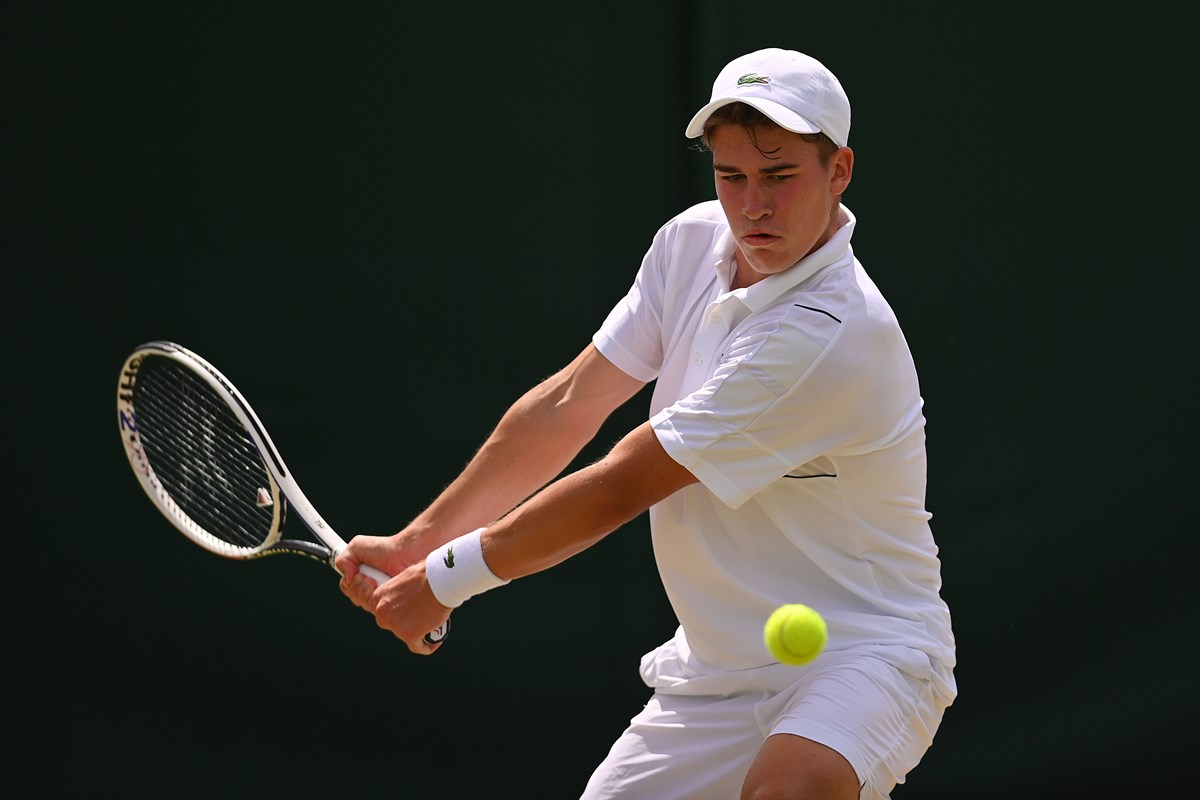 Male tennis player returning a shot in a rally 
