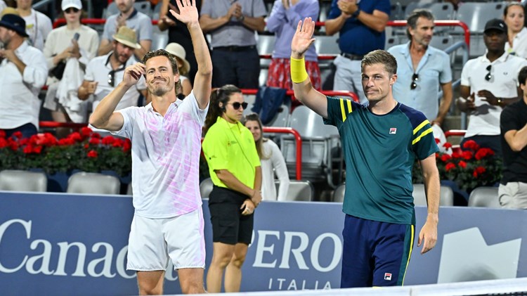 Two male players lifting their hands